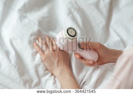Young Woman Hold A Brush To Clean Face And Massage. Top View