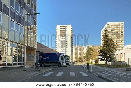 Strasbourg, France - Mar 24, 2020:geodis Cargo Truck Unloading Food At Supermarket Depot With Apartm