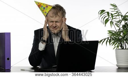 Drank Sleepy Young Clerk Man With Hangover Sitting At The Office Desk Having Headache. Emotions. Dis