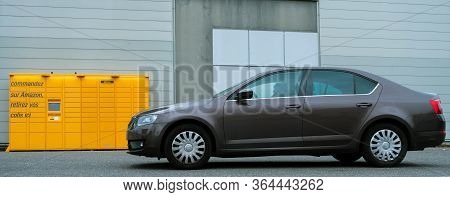 Paris, France - Mar 29, 2020: Side View Of New Skoda Octavia Car In Front Of Yellow Amazon Locker - 