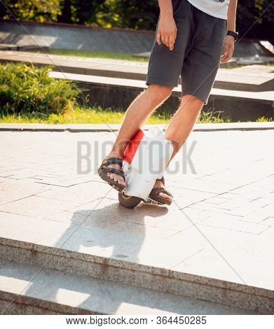 Young Man Driving On Solowheel In The Park.