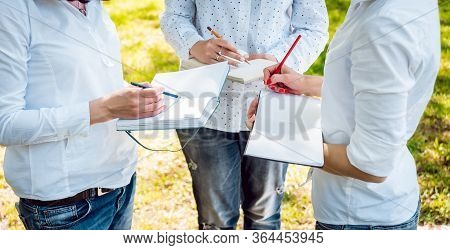 Young Beautiful Girls Drawing The Pictures In Sketchbook.