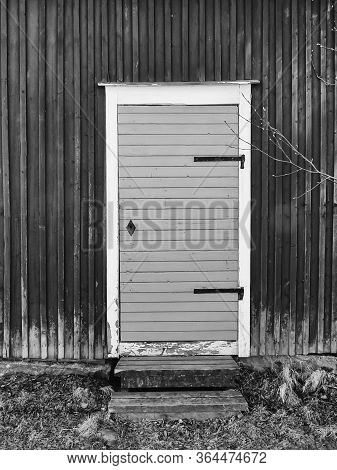 An Old Yellow Door Of A Wooden Red Building At A Fishing Village In The Northern Finland.