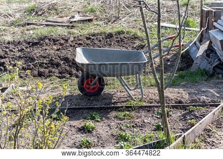 An Empty Construction Car Is Standing In The Garden.