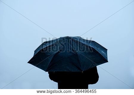 Alone Man Standing Out In Rain With An Umbrella