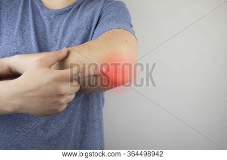 A Man Suffers From Elbow Pain. Damaged Elbow Joint, Bone Fracture, Or Sprain. Hand Injury And Flexio