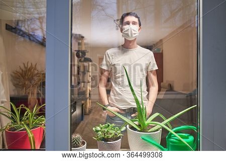 Man With Medical Mask On Their Faces Looking Through Window, Stay At Home, Selfisolation To Prevent 