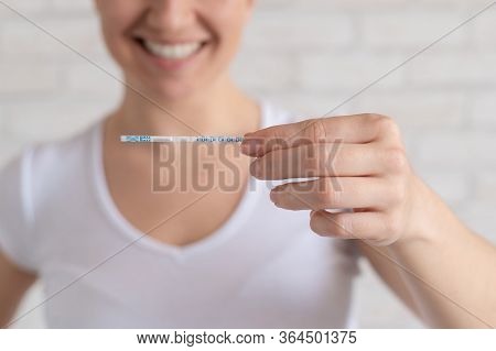 Happy Woman Shows A Negative Ovulation Test. The Concept Of Female Fertility And Luteinizing Hormone