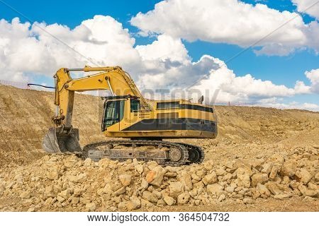 Excavator In A Quarry Extracting Stone