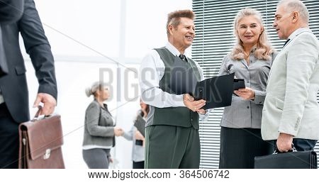 Close Up. Group Of Employees Discussing Documents Standing In The Office