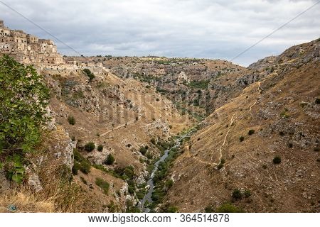 View Of Gravina River Canyon And Park Of The Rupestrian Churches Of Matera With Houses In Caves Di M
