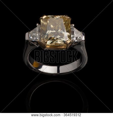 Jewelry, Golden Ring With A Diamond On A Black Background, Reflection From A Shiny Surface.