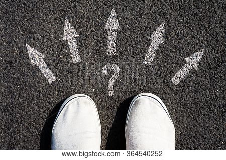 Choice Of Solutions, Paths, Strategies. Sneakers And Arrows In Different Directions On Asphalt. The 
