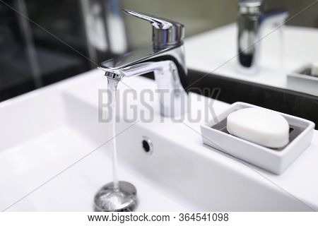 Close-up Of Bathroom Silver Crane. Modern Bath Plumber. Clean And Nice Home Furniture. Water Pressur