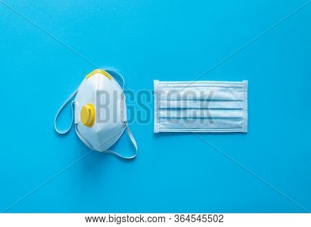 Medical Protective Mask And Respirator Ffp Lie On A Blue Background. Anti-virus Protection Kit Again
