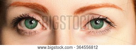 Letterbox View Of Female Blue Eyes Tinted In Green Colour With Special Contact Lenses Close-up
