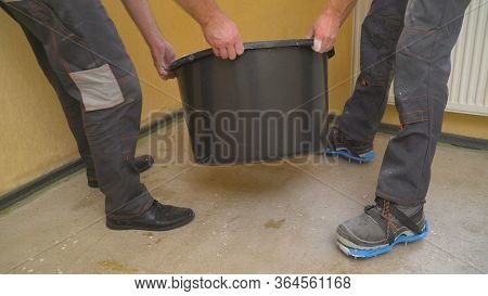 Builders Pour Mortar To Level The Floor. Workers Fill The Self-priming Floor On The Concrete Floor. 