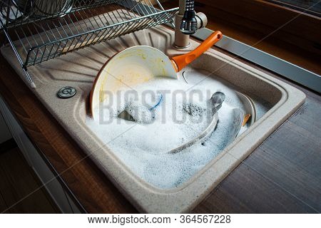 Image Of Dirty Dishes In Sink With Bubble.