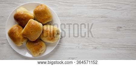 Home-baked Beef Russian Bierocks On A White Plate On A White Wooden Background, Top View. Flat Lay, 