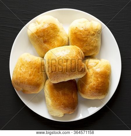 Home-baked Beef Russian Bierocks On A White Plate On A Black Background, Top View. Flat Lay, Overhea