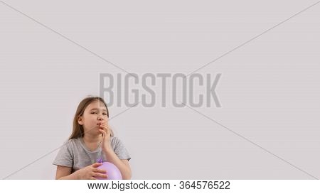 Young Sad Girl Play With Protective Medical Glove. Teenager With Glove Inflated Like Balloon. Quaran
