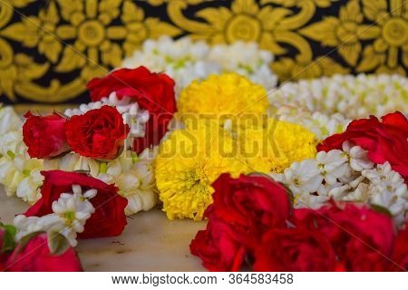 Withe, Red And Yellow Flower Offering In A Temple