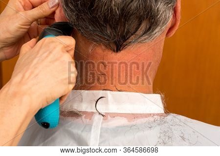 Man Having The Hair Cut On The Back Of His Neck And Head With An Electric Razor