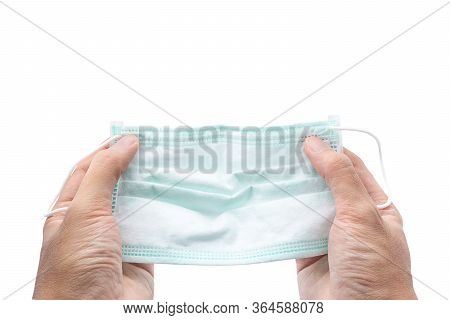 Hand Holding Hygienic Mask Or Surgical Earloop Face Mask Isolated On White Background With Clipping 