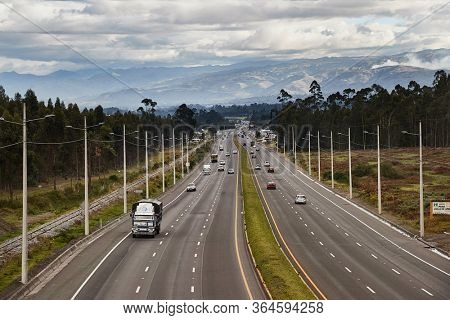 COTOPAXI, ECUADOR - MAY 10, 2019: Traffic on the Pan-American Highway, exit for the Cotopaxi National Park, a popular touristic place