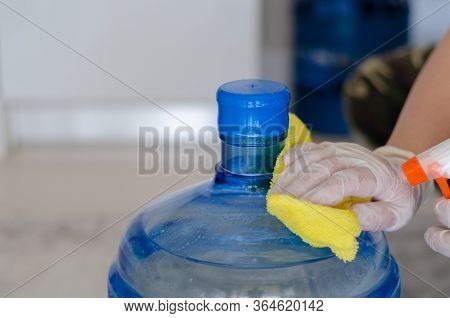 The Woman Disinfects The Carboy In The Kitchen To Protect It From Coronavirus.