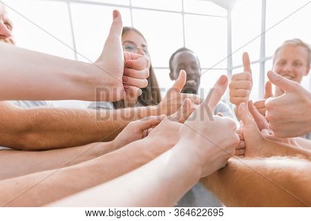 Close Up. A Group Of Young Like-minded People Showing Their Suc