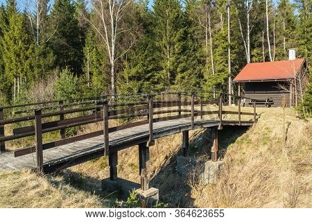 Fishermans House With A Wooden Pedestrian Bridge On A Tiny Island In The Middle Of The Lake. Autumn 