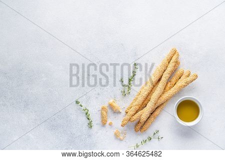 Organic Italian grissini or salted bread sticks and bread lying on a gray background. Fresh Italian 