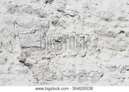 Abstract Texture Of Coastal White Stone For Background, Close-up. Rough, Uneven Surface Of The Rock 