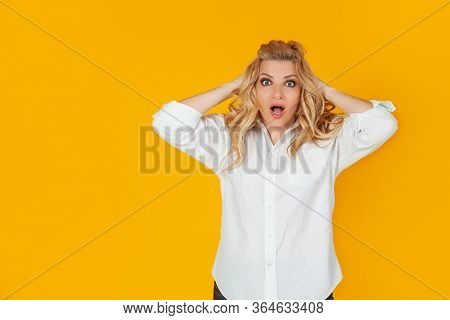 Portrait Of A Woman In A Panic With Her Hands Clutching Her Head, Excited And Looking Panicky Down, 