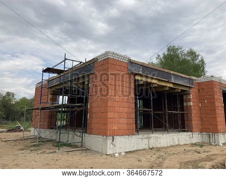 Close Up Of Unfinished House In Residential Area. Modern Architecture Of Construction Brick House Fo