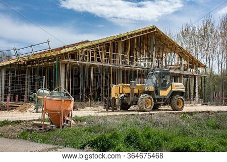 Construction Of A Single-family House With Professional Tools: Concrete Mixer, Scaffolding And A For