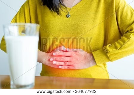 Woman Having A Stomach Pain And A Glass Of Milk,allergy Dairy Intolerant,lactose Intolerance Concept