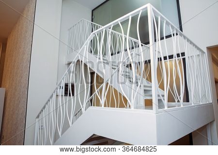 Two-storey Iron White Stairs For Office . Interior Of A Modern Living Room With A Staircase. Home Bu