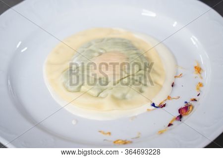 Delicious Raviolo Pasta On A Creamy Sauce. Italian Cuisine