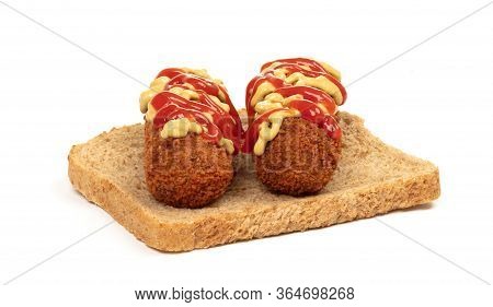 Brown Crusty Dutch Kroket With Mustard Topping Isolated, On A Piece Of Bread, On A White Background