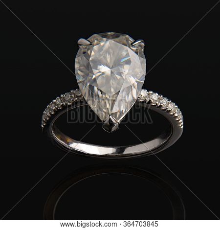 Jewelry, Golden Ring With A Diamond On A Black Background, Reflection From A Shiny Surface.