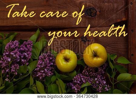 Bright Yellow Apples, Purple Lilac Flowers With Fresh Green Leaves On Wooden Background Flat Lay.col