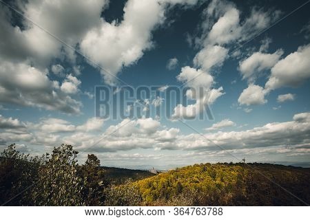 Dramatic And Big White Clouds On The Crystal Blue Sky Over The Green Hills In Spring.  Perfect And M