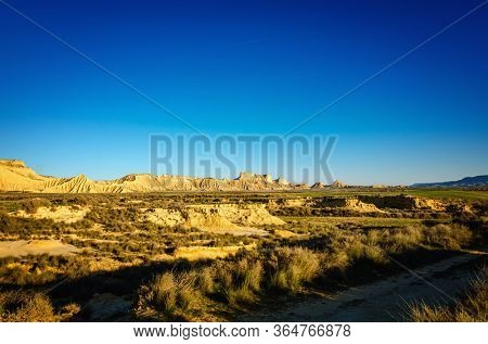 Bardenas Reales is a Spanish natural park of wild beauty, it is a semi-desert landscape in which erosion has carved whimsical shapes to create almost lunar effects with badlands and lonely hills