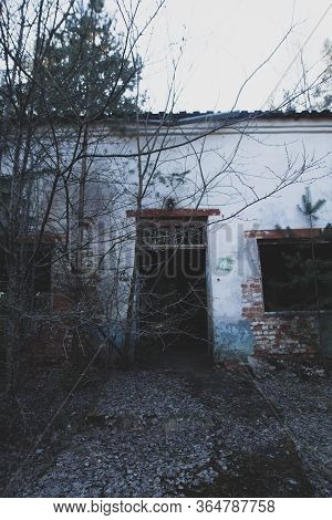 Old Abandoned Soviet Age Camp: Ruined Damaged Buildings In The Forest. Sad, Depressive Post-apocalyp