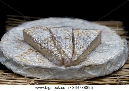 Cheese Brie. Cheese Brie With Triangle Pieces Out Placed On Top. Round Soft Cheese Brie.