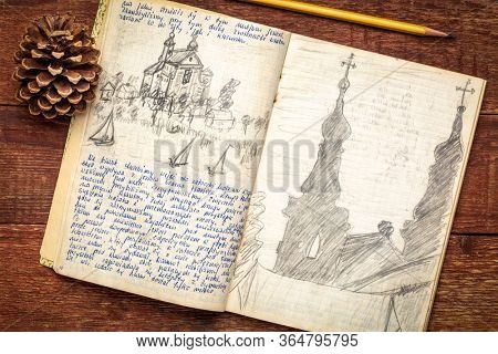 Vintage expedition journal on a rustic wood table  - handwriting and drawing in pencil from a kayak trip in Poland in summer of 1974.