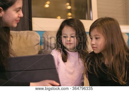 Mother Doing Lessons With Children On A Tablet