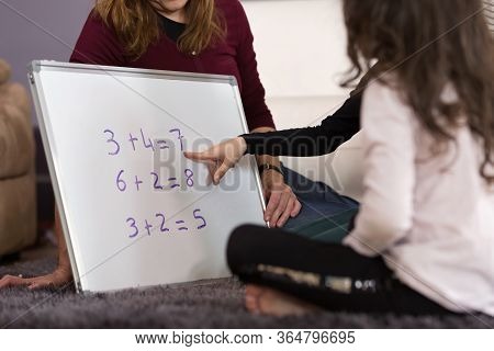 Mother Homeschooling Her Little Girls